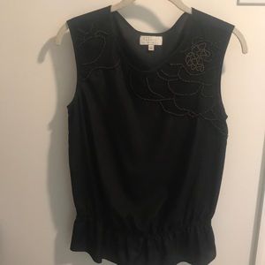 Sleeveless top with beaded accent around neck